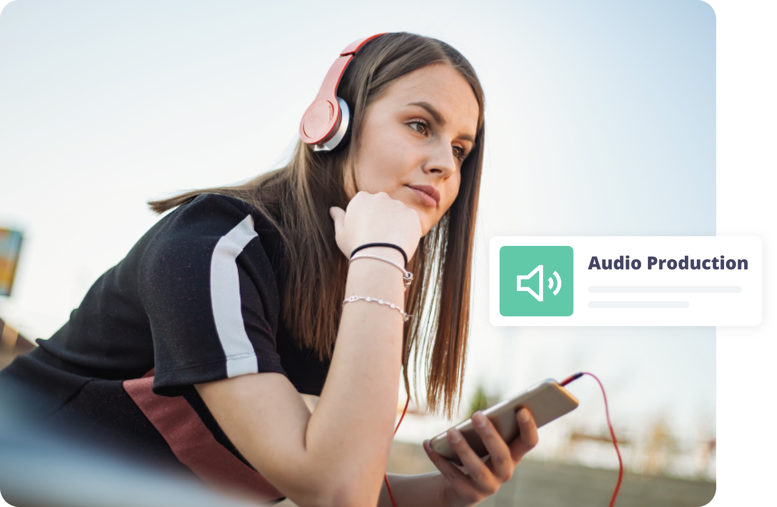 Young woman listening to music on her phone, wearing headphones.