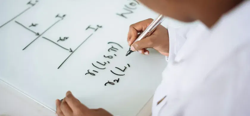 Person deriving formula on white board - improve STEM accessibility with text to speech for math