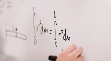 Someone writes a mathematical formula on the board