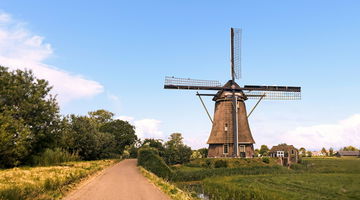 A windmill on the side of a country road