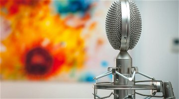 A microphone placed in front of a painting