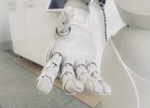 A white robot hand stretched forward