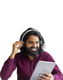 Indian man wearing wireless earphones using tablet