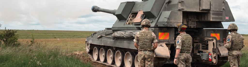 An assault tank and soldiers around