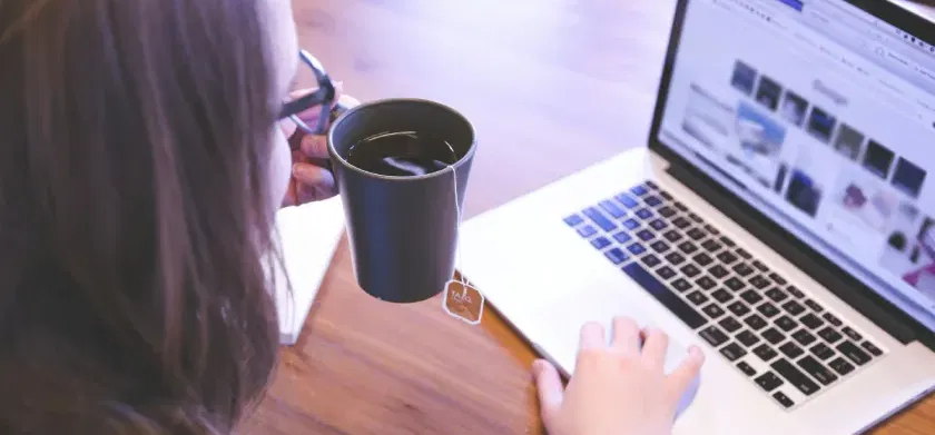 Woman using laptop discovering closing digital divides: ReadSpeaker TTS and the 2024 National Edtech Plan