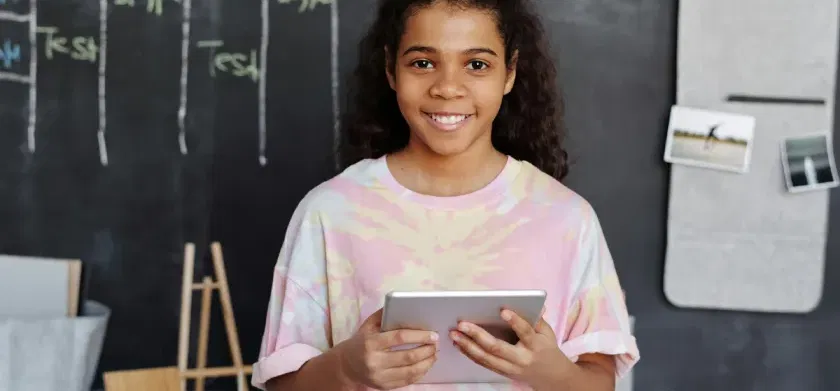 A student with a tablet using text-to-speech tools for education: Speechify Vs. ReadSpeaker