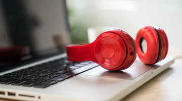 Red headphones on a laptop.