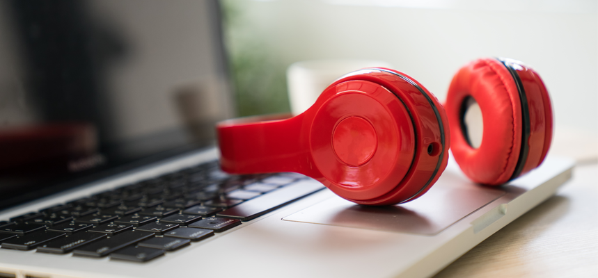 Red headphones on a laptop.