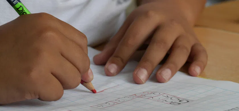 A student writing in a white graphing notebook. Inclusive education in the UAE: the role of EdTech