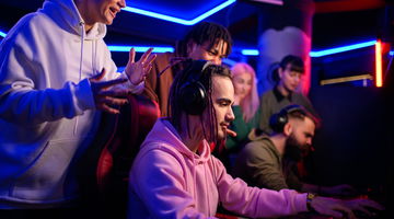 Pro eSports gamer diverse team playing online strategy video game.