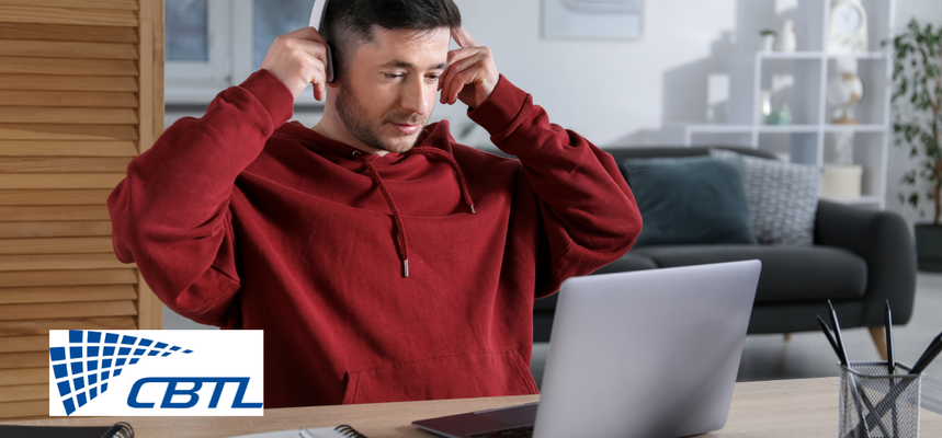 Man with headphones using a laptop.