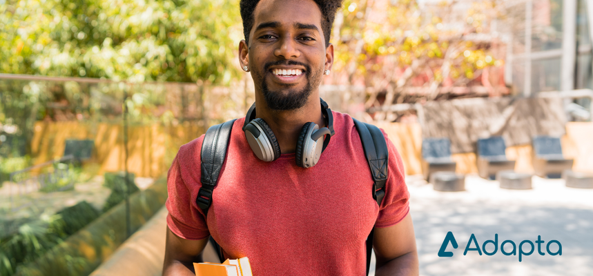 Young man with red shirt smiles to the camera.
