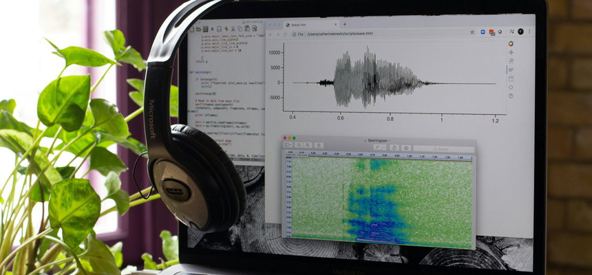 An open laptop showing soundwaves, representing spoken audio.