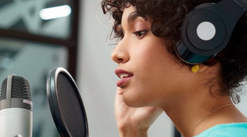 Voice talent recording speech in a professional studio.