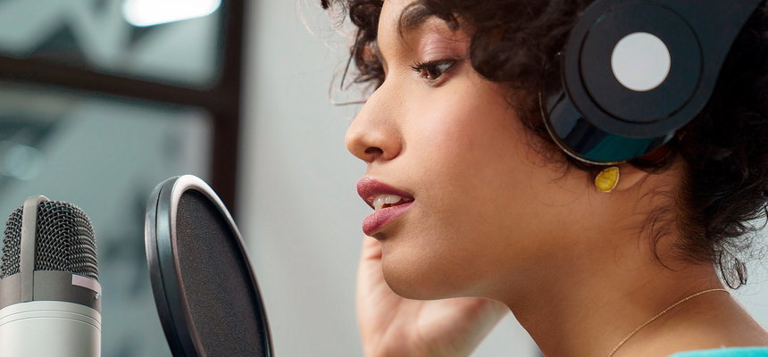 Voice talent recording speech in a professional studio.
